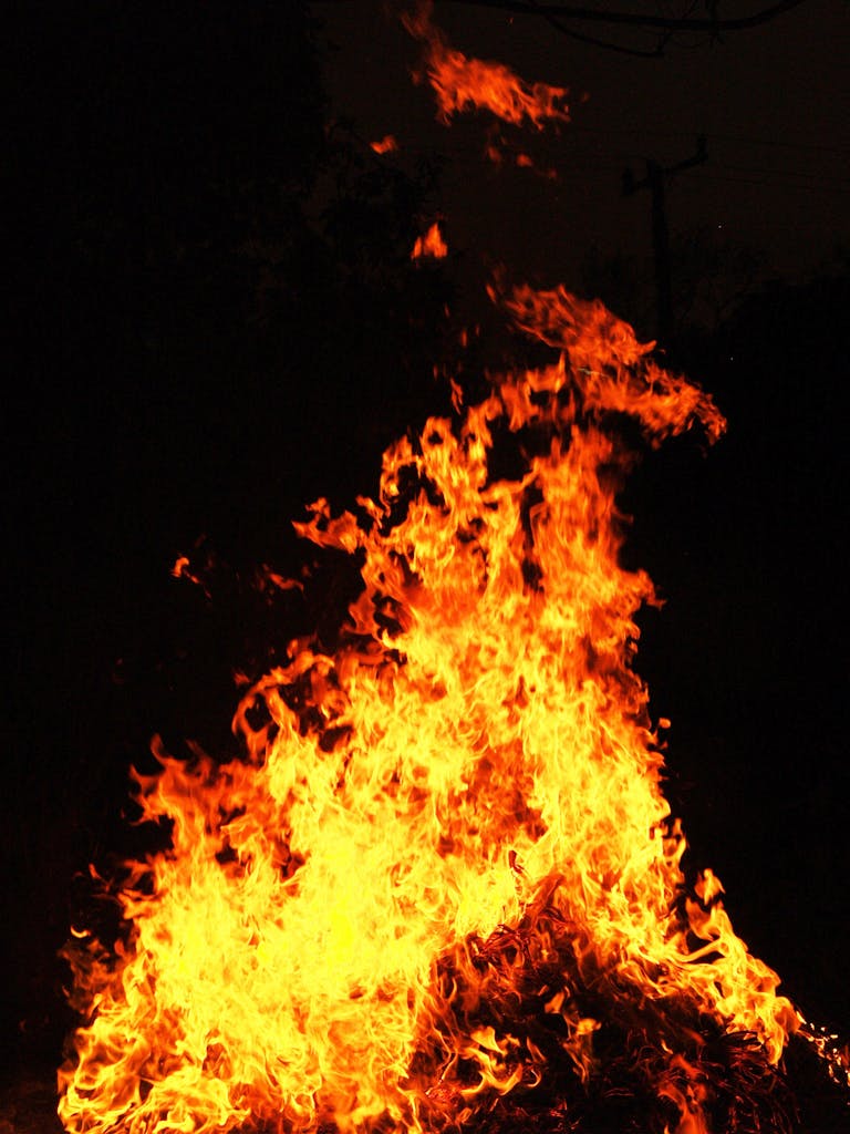 Dynamic image of a blazing bonfire with vivid flames lighting up the night.